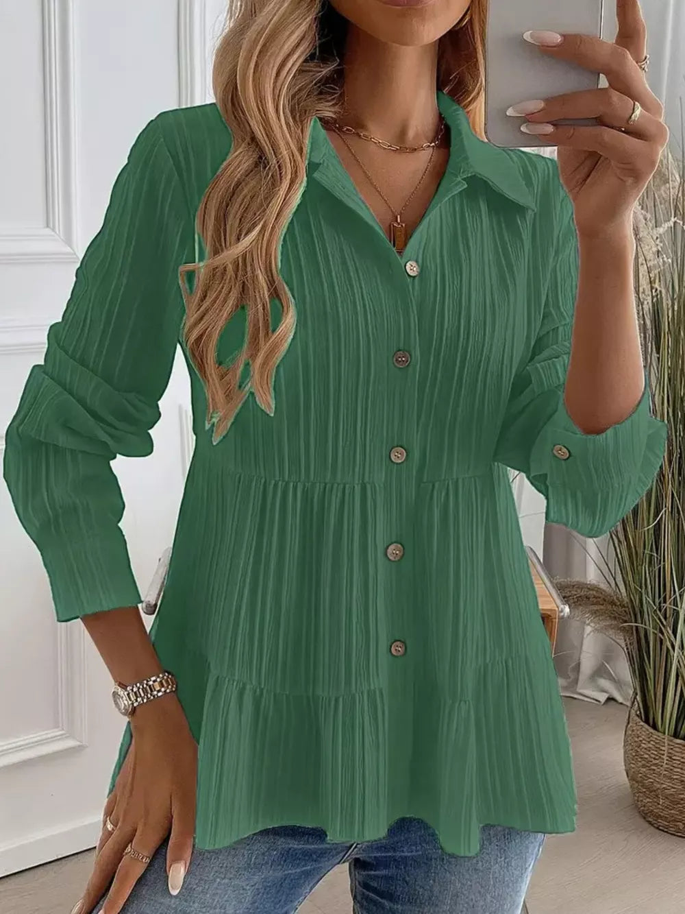 Green textured tiered button-down shirt with crinkled fabric and button details.