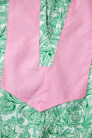 Botanical print midi dress with pink V-neck detail and flutter sleeves.