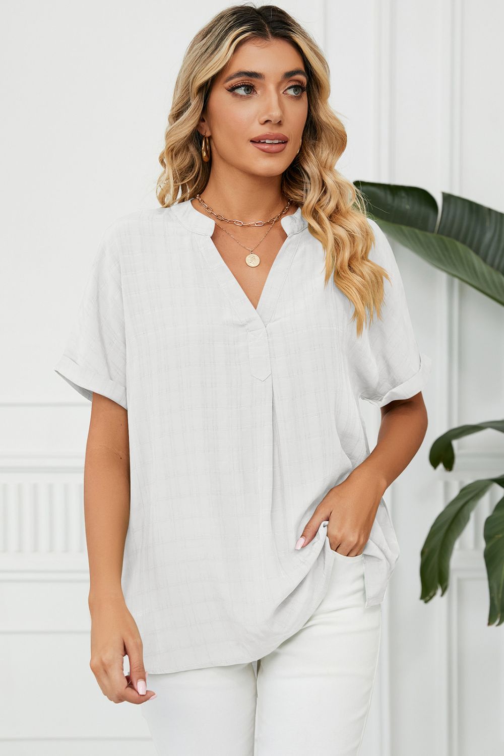 White linen blend blouse with V-neck, short sleeves, and subtle plaid texture.