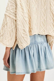 Light blue denim ruffle mini skirt with a cinched waist and tiered hem.
