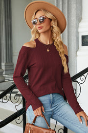Burgundy textured cable knit cold shoulder top with long sleeves.
