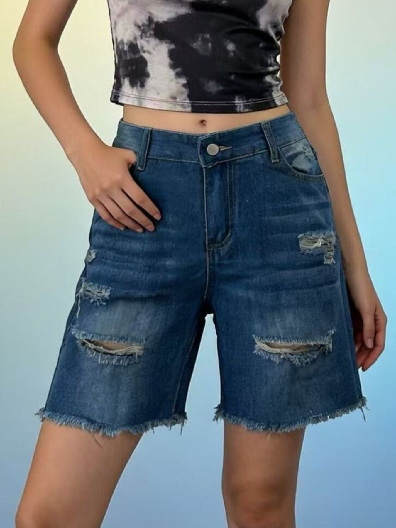 Distressed dark blue denim shorts with frayed hem and ripped details.
