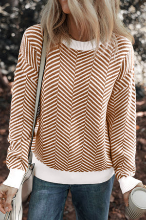 Chevron knit crewneck sweater in camel and white with white trim and cuffs.