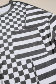 Asymmetrical checkered patchwork knit top with striped pocket in black and white.