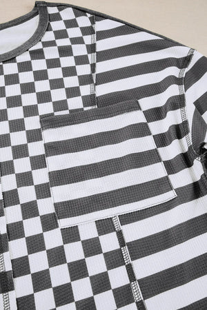 Asymmetrical checkered patchwork knit top with striped pocket in black and white.