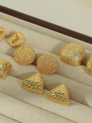 Gold textured cube earrings in various geometric shapes and finishes.