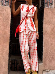 Red fish print sleeveless top and wide leg pants set with gold button details.