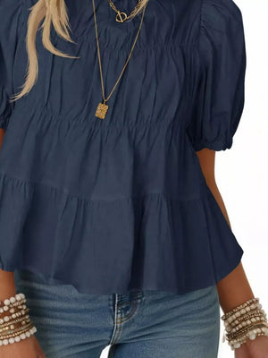 Dark blue maternity blouse with puff sleeves, ruffled tiers, and smocked bodice.
