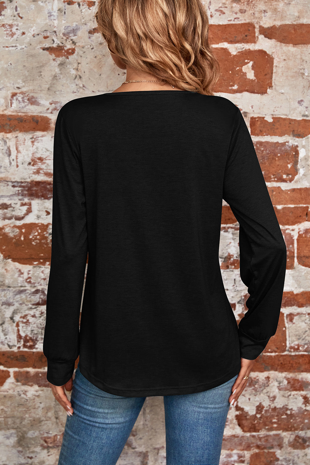 Black long sleeve top with square neckline and subtle pleats, casual chic style.