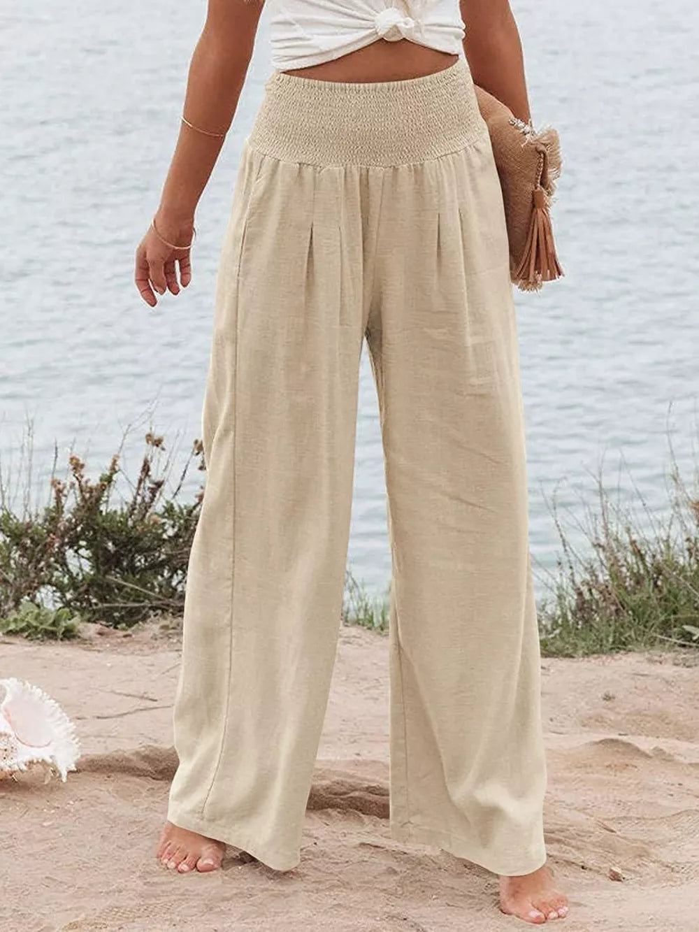 Tan smocked wide-leg maternity pants with a relaxed fit and flowy silhouette.
