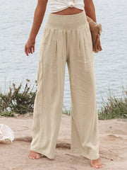 Tan smocked wide-leg maternity pants with a relaxed fit and flowy silhouette.