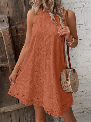 Caramel halter neck eyelet trapeze dress with floral cutouts and a scalloped hem.