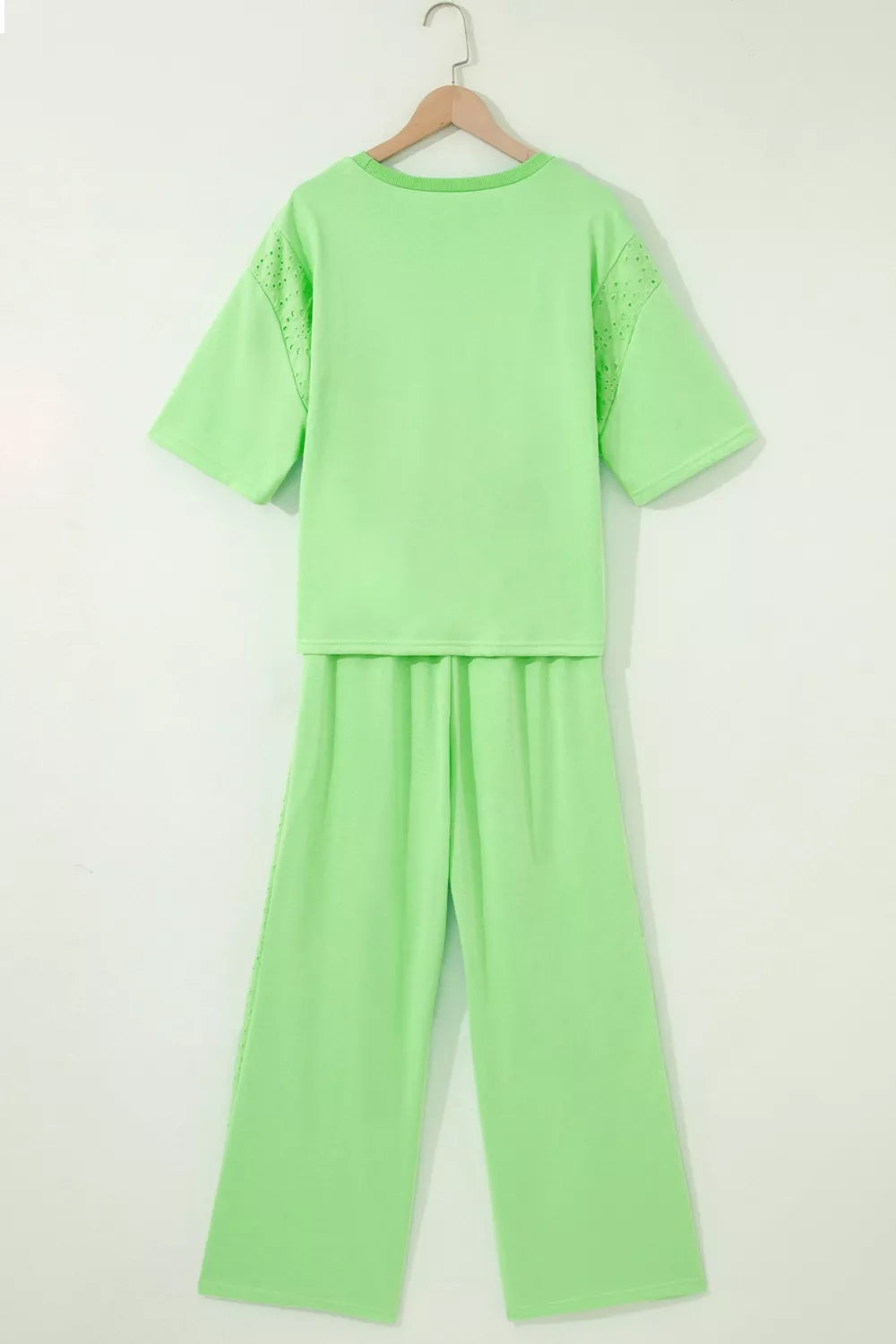 Light green cotton eyelet two-piece set with drawstring pants and short sleeves.