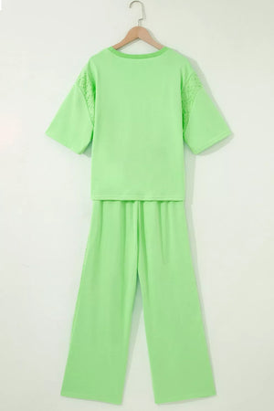 Light green cotton eyelet two-piece set with drawstring pants and short sleeves.