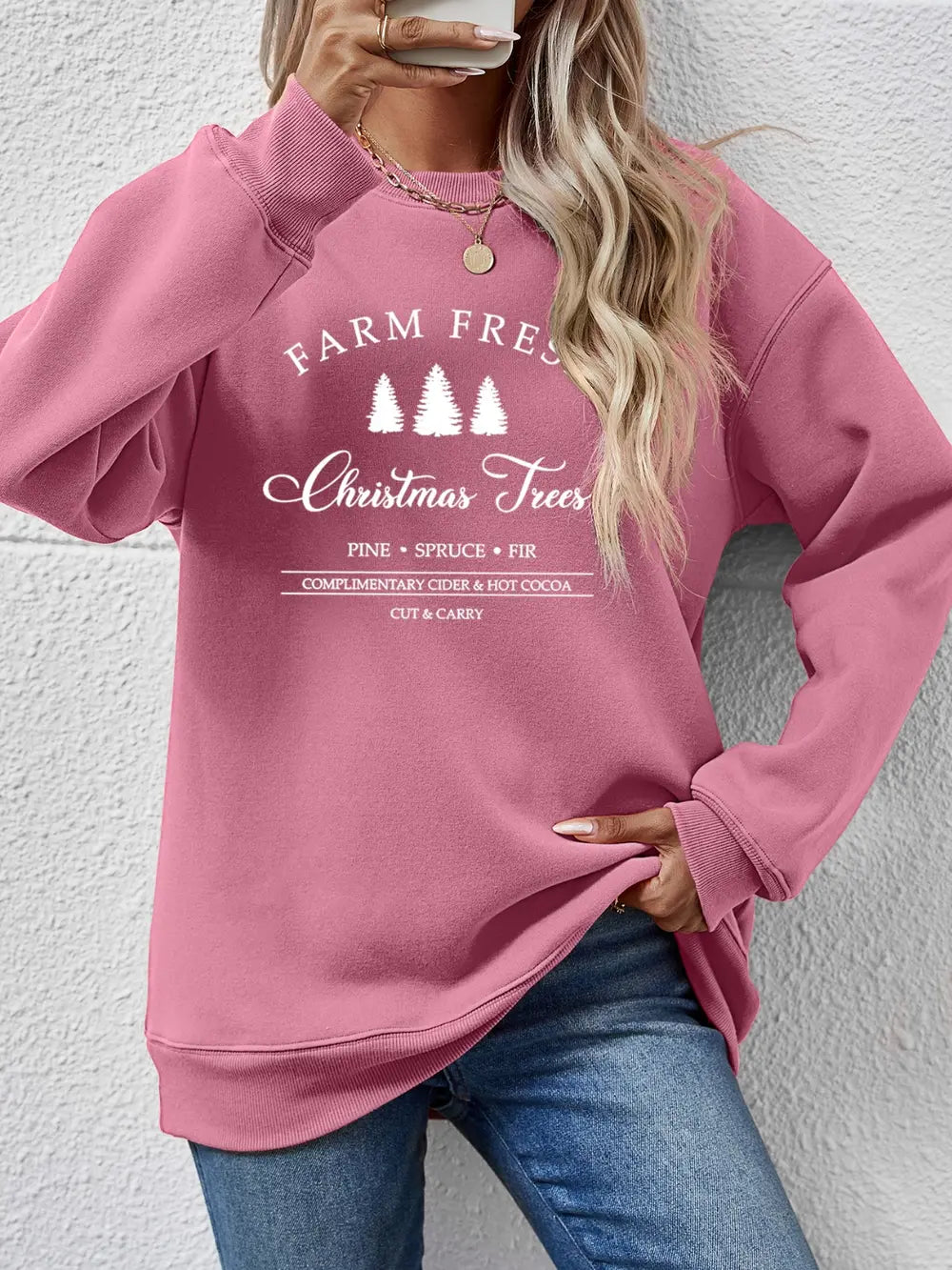 Blush pink graphic sweatshirt with "Farm Fresh Christmas Trees" print and crew neck.