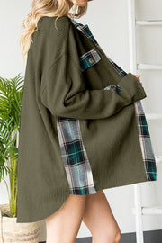 Green waffle knit overshirt with plaid trim and button details.