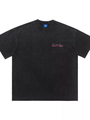 Black cotton t-shirt with pink retro graphic and crew neck.