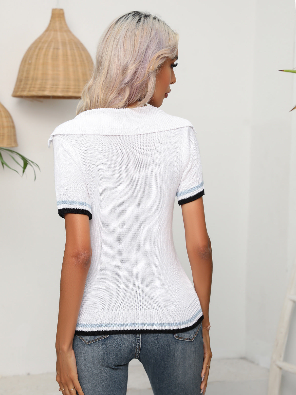 White openwork knit polo top with short sleeves and striped trim.