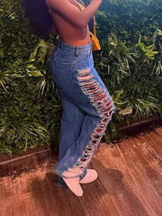 Blue cotton blend jeans with distressed side cutouts and lace-up detail.
