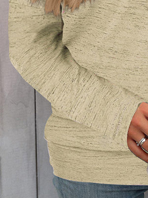Off-the-shoulder heathered knit top in tan, showing textured fabric and long sleeves.