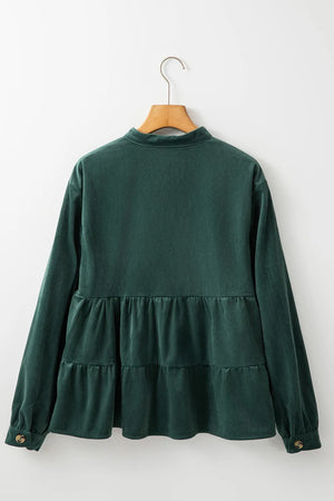 Dark green corduroy tiered button-up blouse with long sleeves and button cuffs.