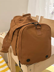Caramel oxford cloth travel organizer bag with detachable strap and zippered compartments.
