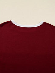 Burgundy long-sleeve top with white trim neckline.