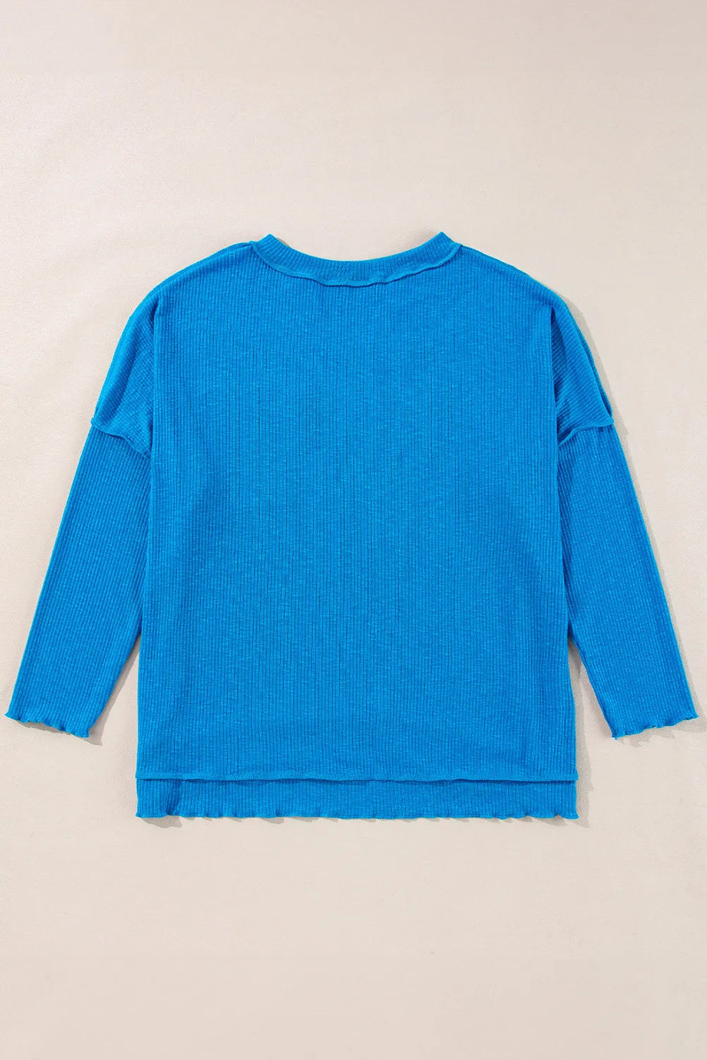 Sky blue textured thermal top with cutout neckline and lettuce hem details.