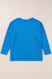 Sky blue textured thermal top with cutout neckline and lettuce hem details.