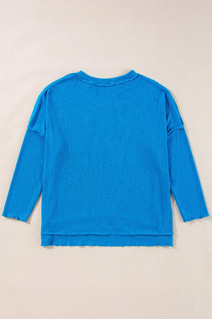 Sky blue textured thermal top with cutout neckline and lettuce hem details.