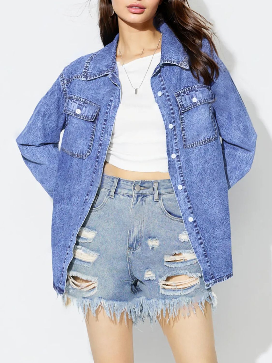 Acid wash denim overshirt in medium blue with two chest pockets and button front.