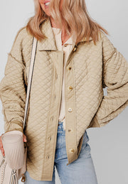 Beige diamond quilted oversized button-up jacket with a collared neckline and button closure.
