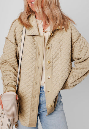 Beige diamond quilted oversized button-up jacket with a collared neckline and button closure.