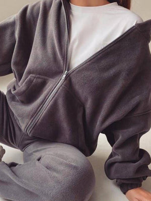 Dark Gray fleece zip-up hoodie with front pocket, worn over a white t-shirt.