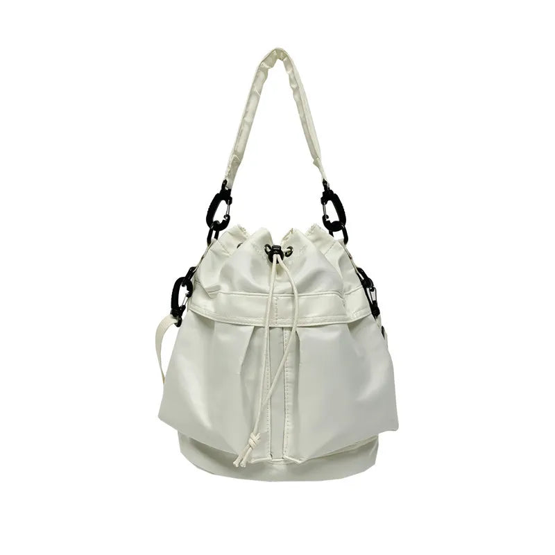 White nylon drawstring bucket bag with chain detail and carabiner clips