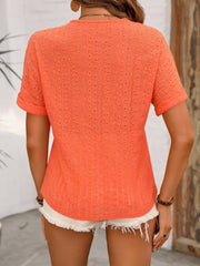 Orange-Red eyelet henley top with short sleeves and relaxed fit, styled with white shorts.
