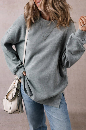 Relaxed fit dark gray ribbed sweatshirt with V-stitch detail at neckline and side slits.