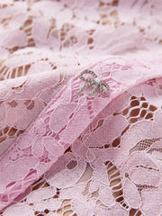 Powder floral lace mermaid dress detail with rhinestone bow belt accent.