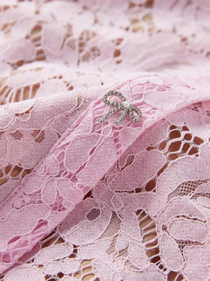 Powder floral lace mermaid dress detail with rhinestone bow belt accent.