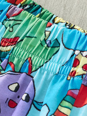 Toddler shorts with elastic waistband and cartoon dinosaur print in blue, green, and purple.