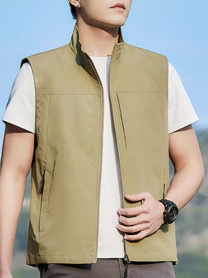Khaki zip up vest with stand collar and zippered pockets, worn over a white t-shirt.