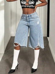 Distressed light wash denim wide-leg shorts with raw hem and ripped details.
