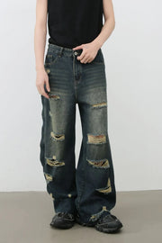 Distressed dark wide leg denim jeans with side slits and frayed hems.