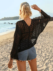 Black crochet knit beach cover-up with V-neck and frayed hem details.