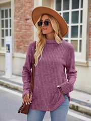 Ribbed turtleneck sweater in Fuchsia with side slits and bell sleeves.