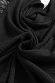 Black ribbed knit blouse with ruffled faux leather sleeve detail