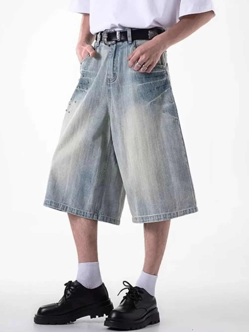 Relaxed fit light blue denim shorts with coin pocket and distressed details.