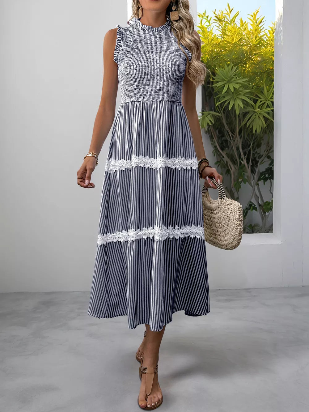Navy blue striped midi dress with smocked bodice and lace trim.