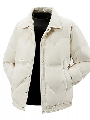 Ivory padded puffer jacket with button-down front and collar, worn over a black turtleneck.