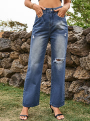 Distressed flare denim jeans in navy with ripped details and a buttoned fly.